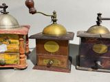 three different types of coffee grinders sitting on a table