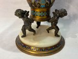 a statue of two cherenshes holding a vase