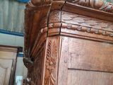 a large wooden cabinet with a mirror on top of it