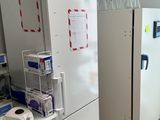 a white refrigerator and a white refrigerator freezer in a room