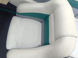 a white and green boat seat with a blue stripe