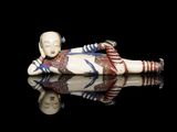 an image of a figurine of a woman laying on her stomach
