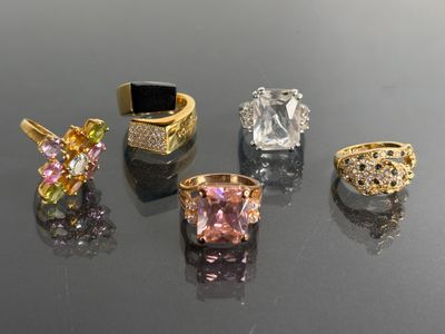 several different colored rings are arranged on a black surface