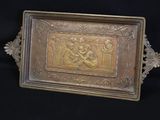 brass plate with a picture of a man and a woman on it