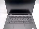 the dell laptop is open and ready to be used on the desk