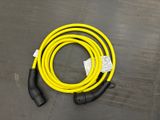 a close up of a yellow hose on a floor