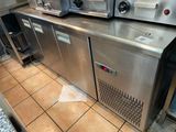 stainless steel counter top in a commercial kitchen with ovens on it