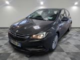 the grey opel is parked in a large room with checkered floor