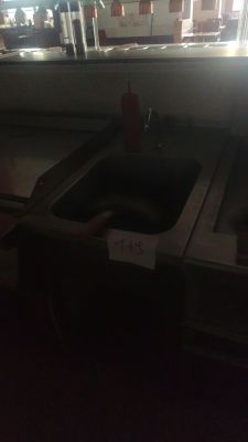 a sink in a kitchen with a lot of counter space