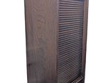 an old wooden cabinet with shutters on top of it