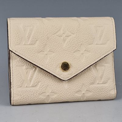 louis vuitton, a white leather wallet with gold hardware