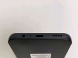 a close up of the back of a cell phone on a white surface