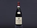 a bottle of wine sitting on top of a black table