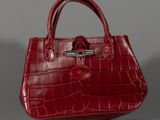 an image of a red purse on a grey background
