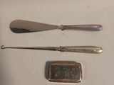 two spoons, a spoon and a spoon rest next to each other
