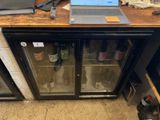 a laptop computer sitting on top of a glass case
