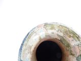 a large vase with a hole in the middle of it