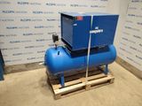 a blue air compressor sitting on a pallet in front of a wall