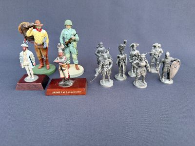 many figurines of soldiers on display on a table