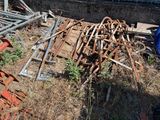 a pile of old rusted metal items on the side of the road