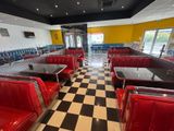 a black and white checkered floor in a diner