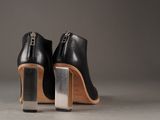 pair of black high heeled shoes with wooden heel and metal heel