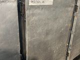 two metal containers that are sitting in a warehouse