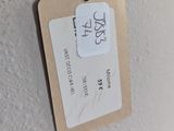 a tag hanging on the wall of a bathroom