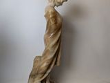 statue of a woman with a hat on her head