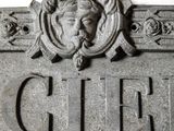 a close up of a sign with a statue on it