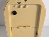 an old yellow mailbox sitting on top of a white table