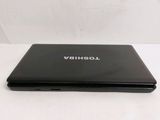 a black laptop on a white table with a white background