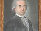 portrait of a man in a black coat with a white bow tie