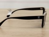 a close up of a pair of sunglasses on a wooden table