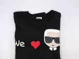 a black t - shirt with a picture of a man wearing sunglasses and a red heart