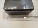 a black box that is sitting on a table next to a ruler