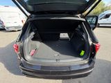 the back of a car with its trunk open in a parking lot