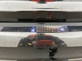 a close up of a car ' s front bumper with a sign on it