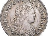 a close up of a coin with a woman ' s head on it