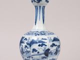 a blue and white vase sitting on a table