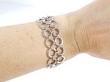 a woman ' s arm with a bracelet on it