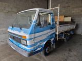 a blue and white truck parked inside of a building