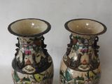 two vases that are sitting on a table