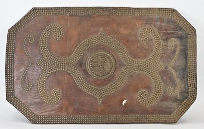 an old wooden tray with a design on it on a white surface