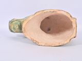 a small vase with a hole in it sitting on a table
