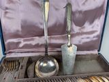 two spoons and a ladle in a case