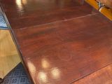 a wooden table with chairs around it in a room