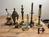 many different types of candles on a wooden table