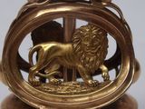 a gold statue of a lion on a pedestal