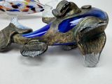 a glass figurine of a fish on a table